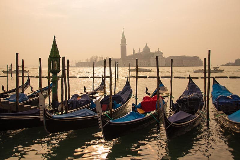 a boat is docked next to a body of water