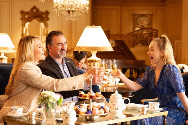 a group of people sitting at a table with food